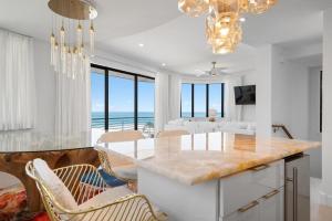 a kitchen and living room with a view of the ocean at Anna Maria Wave in Ilexhurst