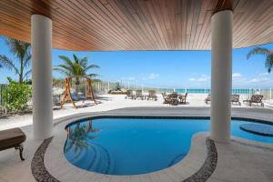 a swimming pool in a house with a view of the ocean at Anna Maria Wave in Ilexhurst