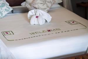a bed with a towel with a flower on it at Savera Beach Houses in Jambiani +91 photos