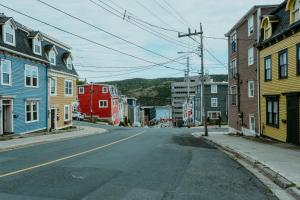 an empty street in a city with colorful buildings at Modern Townhouse in the Heart of Downtown in St. John's