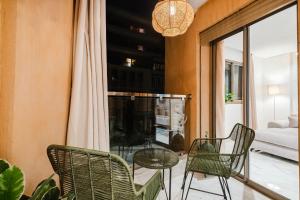 a room with a table and chairs and a window at NEW Apartment Central 1BR-Queensize, AC&Terrace in Marrakech +21 photos