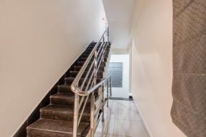 a staircase in a house with a metal railing at Treebo Sapphire Bliss in Hyderabad