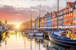 a group of boats docked in a canal with buildings at Hotel Maritime in Copenhagen