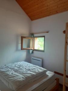 a bed in a room with a window at Cauterets in Cauterets