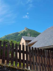 a house with a fence in front of a mountain at Cauterets in Cauterets