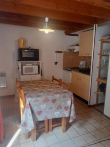 a kitchen with a table with a table cloth on it at Cauterets in Cauterets