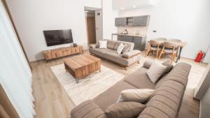 a living room with a couch and a table at Altındere Vadi Hotel in Akyazı