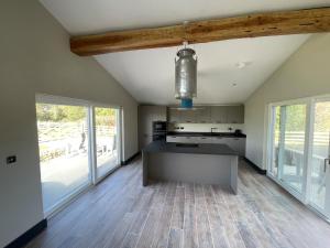a kitchen with a large island in the middle at 1 New Dairy Barn in Sunderland Bridge