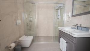 a bathroom with a shower and a toilet and a sink at Altındere Vadi Hotel in Akyazı +44 photos