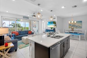 a kitchen with a sink and a living room at One Happy Condo in Bradenton