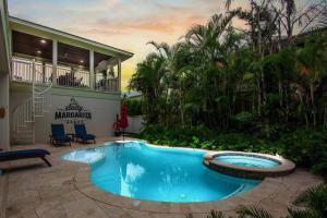 a swimming pool in the middle of a yard at Salty Margarita in Anna Maria Island
