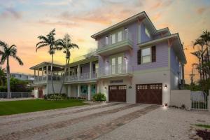 a large house with a purple at Salty Margarita in Anna Maria Island