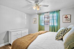 a bedroom with a bed and a ceiling fan at Gulf Haven East in Anna Maria Island