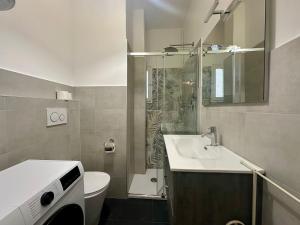 a bathroom with a sink and a toilet and a shower at Casa Susanna Loano in Loano
