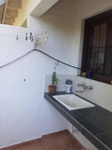 a bathroom with a sink and a plant on a counter at CERCA DEL MAR - Costa Azul in Costa Azul