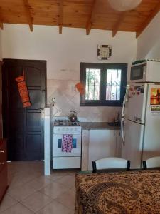 a kitchen with a stove and a refrigerator at CERCA DEL MAR - Costa Azul in Costa Azul