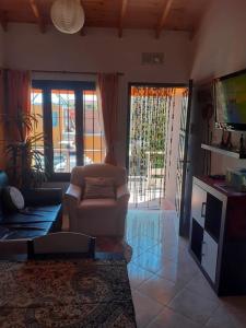 a living room with a couch and a tv at CERCA DEL MAR - Costa Azul in Costa Azul +19 photos