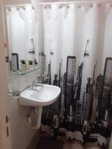 a bathroom with a sink and a city shower curtain at CERCA DEL MAR - Costa Azul in Costa Azul +19 photos