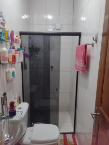 a bathroom with a shower and a toilet and a sink at Casa para COP 30 dois quartos in Ananindeua