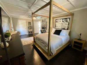 a bedroom with a canopy bed in a room at Luxurious 4BR Oasis - Unwind in a Biking Paradise in Bentonville