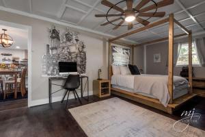 a bedroom with a bed and a desk with a computer at Luxurious 4BR Oasis - Unwind in a Biking Paradise in Bentonville
