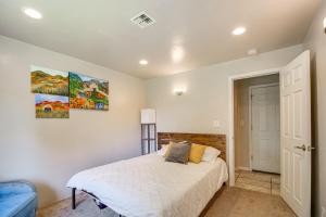 a bedroom with a bed and two paintings on the wall at Walk to Rogue X Medford Family Home with Large Yard in Medford