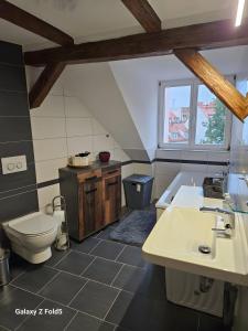 a bathroom with a toilet and a sink and a tub at Ferienwohnung am Dom 2 in Erfurt