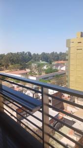 a balcony with a blue bench on top of a building at Ojo Turco Monoambiente Temporario in Santiago del Estero
