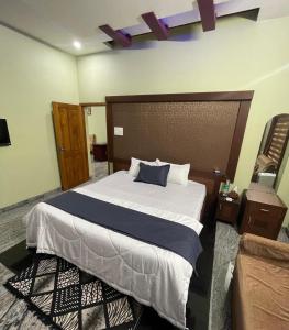 a bedroom with a large bed in a room at Gurukripa Homestay in Kānnangād
