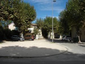 a street with cars parked in a parking lot at Appartement Tout Confort 2-4 in Joyeuse