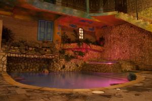 a large swimming pool in a building with purple lighting at Villa Salomé Apartamentos Turísticos in Duitama