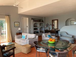 a living room with a couch and a table at Country House With Private Pool in Poço do Álamo