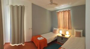 a bedroom with two beds and a window at Country House With Private Pool in Poço do Álamo +14 photos