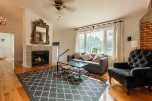 a living room with a couch and a fireplace at The Prince Edward County Church, A Unique Escape in Belleville +68 photos
