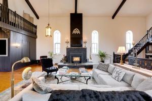 a living room with a couch and a fireplace at The Prince Edward County Church, A Unique Escape in Belleville
