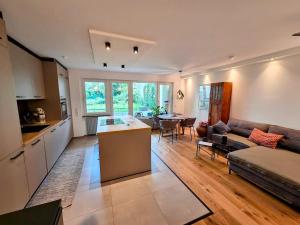 a kitchen and living room with a couch and a table at Design-Wohnung im Zentrum mit Balkon und Parkplatz in Offenbach