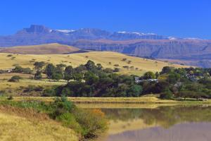 a large body of water with mountains in the background at Treks, Trips and Trails in Champagne Valley +7 photos