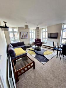 a living room with a couch and a table at Rochester Apartment in Bedford