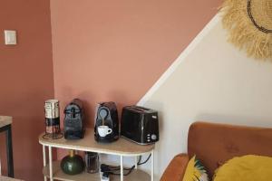 a small table with toaster and toasters on it at Nid confort proche du canal du midi 2 terrasses Labège in Labège