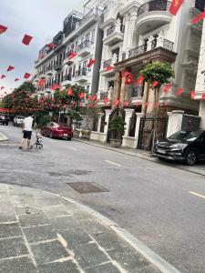 a man walking down a street in front of a building at Tâm Anh Hotel in Hanoi