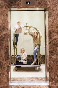 a woman and two children in a display case at The Ritz-Carlton, Vienna in Vienna