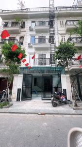 a motorcycle parked in front of a building at Tâm Anh Hotel in Hanoi