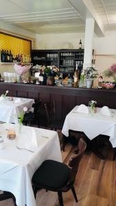 a restaurant with two tables with white table cloths at Pension Zum Adler in Limbach