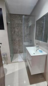 a white bathroom with a shower and a sink at حي الواحات in Tunis +11 photos