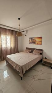 a bedroom with a large bed in a room at حي الواحات in Tunis