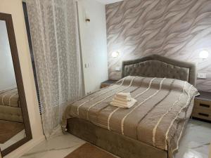 a bedroom with a bed and a large mirror at Holiday Home - Si Do Relais in Pozzuoli