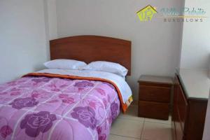 Postel nebo postele na pokoji v ubytování Bungalow Villa Pedrito