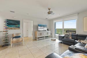 a living room with a couch and a tv at Oceanwalk 17-502 in Chicken Island