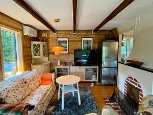 a living room with a couch and a table at Pine Hill in Karlarp +44 photos