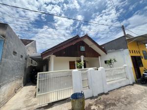 a house with a white fence in front of it at 55 Ketapang Homestay in Ketapang